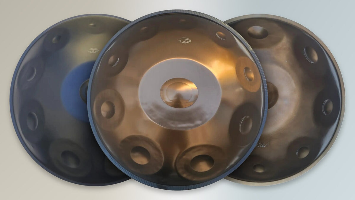 Handpans in nitrided steel, stainless steel and Ember Steel side by side, seen from above.